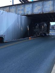 Illustration for article titled A Truck Hauling Exotic Cars Crashed Into A Different Low-Ass Bridge